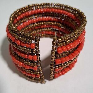 Large multi strand beaded bracelet in orange red gold brown